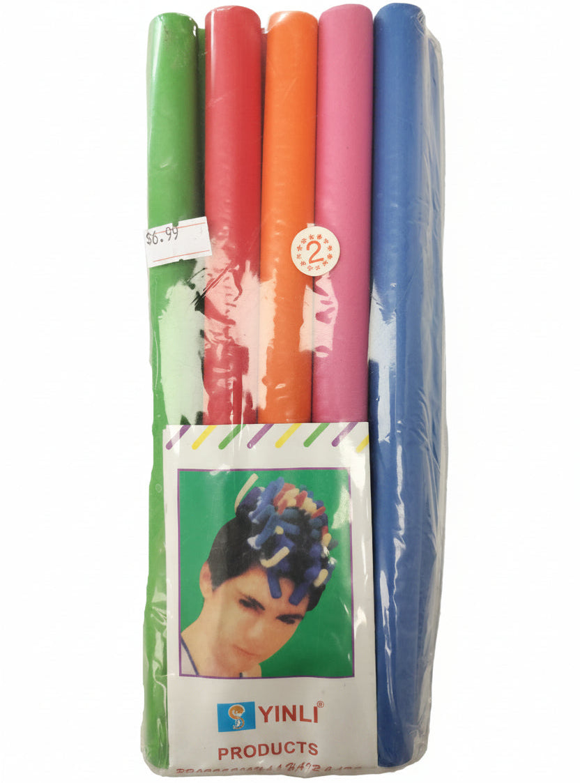 Packaged hair curlers with colorful bands on a marble surface